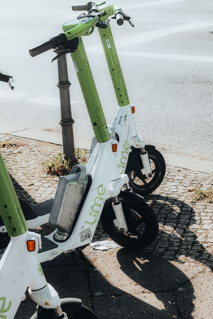 Electric scooters parked outdoors in Berlin, showcasing urban mobility and green transportation.